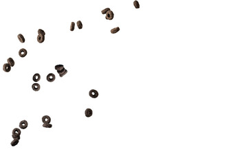 Chocolate rings cereal spill out into a bowl. Breakfast.