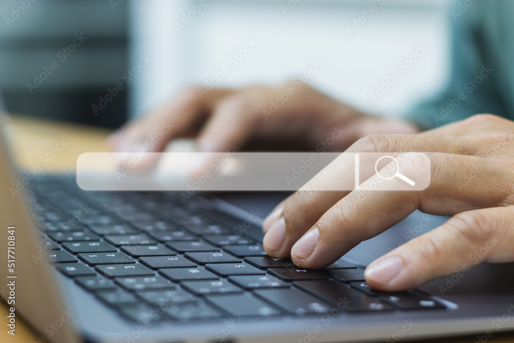 Aufkleber close-up of a man's hands typing on a laptop keyboard. and has a white search icon the concept of us