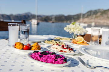 Luxurious restaurant table ready to serve at the coast of Mediterranean Sea