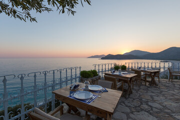 Beautiful place art the coast of Mediterranean Sea for relaxation at summer time. Tables of the restaurant ready to eat
