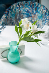 White flowers in classic blue glass
