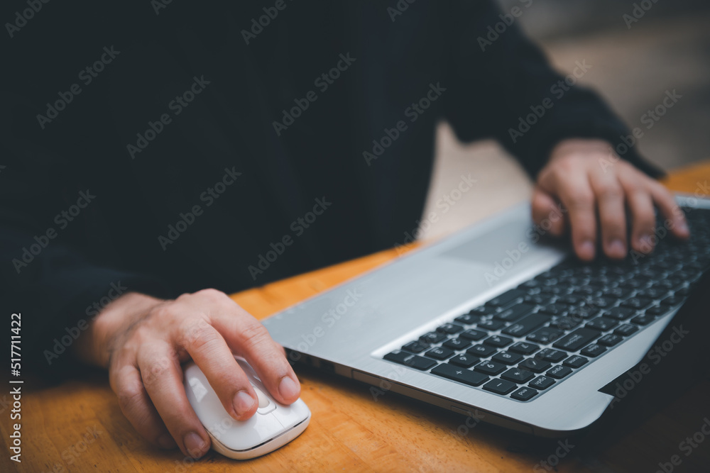 Poster closeup image of a business man's hands working and typing on laptop computer keyboard on office tab