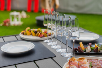a set table in a restaurant in nature. photo of glasses
