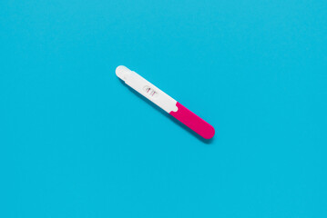 positive pregnancy test on a blue background