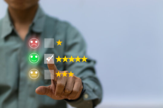 customer service concept,Businessman presses check mark with star icon on blurry background. Business Satisfaction and Acceptance Survey