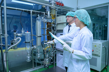 Scientists and assistants are in the machine room extracting oil and cannabis seeds. Inspecting...