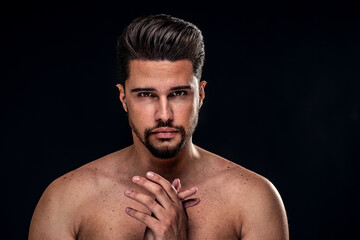Beauty portrait of handsome, sexy male model with beard looking at the camera. Shirtless man.
