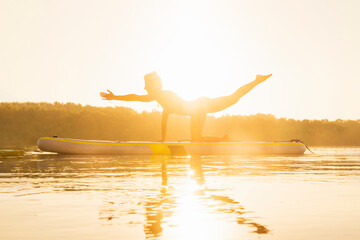 Silhouette of a woman stretching her body during the calm of the day.