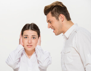 the boss scolds the young subordinate.close-up portrait of two workers on a white background isolated.the man yells at the girl.teaches the girl.points out the mistakes.