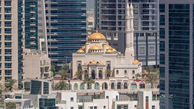 Dubai Marina skyline with Mohammad Bin Ahmed Al Mulla mosque aerial timelapse. Skyscrapers with glass surface on a background. Palms around