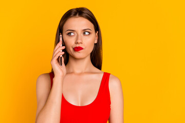 Photo of pretty girl speak communicate telephone hesitate think isolated on yellow color background