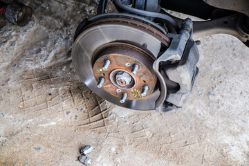 Car disk brake repair in garage - obrazy, fototapety, plakaty