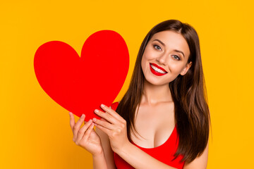 Photo of sweet adorable lady dressed bodysuit holding big red heart smiling isolated yellow color background
