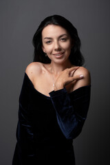 Classy Young pretty woman  in an evening dress smiling and posing and looking at  camera