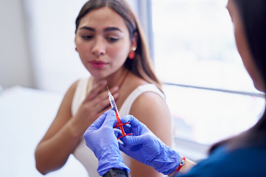 Esthetician With Syringe Before Making Collagen Injection