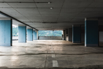 Empty parking lot on the floor with thick blue columns at day