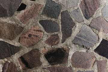Close up to a stone wall with texture. Surface made of rocks and concrete