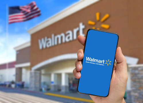Los Angeles, California, USA - June 13, 2022 - Walmart retailer delivery application on smartphone holding by hand with blurry background.