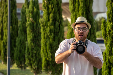 photographer at park with camera professional guy on the photoshoot in hat shocked