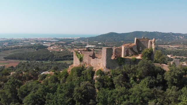 Fall in love with Spain.  Visit the Castell de Palafolls in the cultural heart of Barcelona, Cataluña, Spain.  The landscape comes into view as a drone orbits the castle and brings history to life.