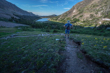 Hiker looking down at Lawn Lake in Rocky Mountain National Park Colorado