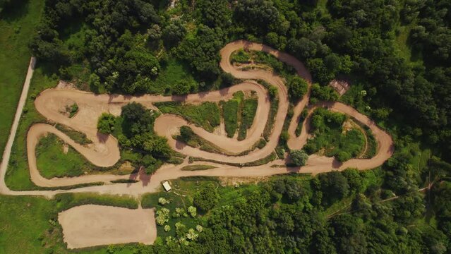 Motocross track in the middle oa greenf countryside. Horizontal drone shot. High quality 4k footage