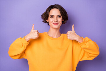 Portrait of charming satisfied girl two arms fingers demonstrate thumb up approve isolated on...