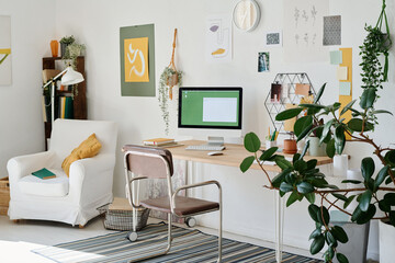 Part of living room with workplace of freelance webdesigner or other creative profession by wall...