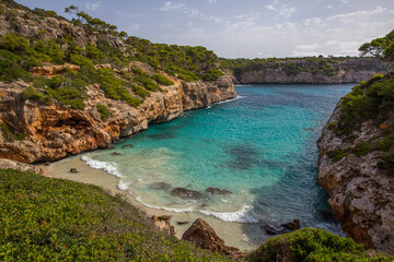 Obraz premium Mallorca, Spain - 08 12 2017 deserted beach in the mediterranean emerald green sea