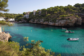 Mallorca, Spain - Boats in a cove in the mediterranean sea blue green color