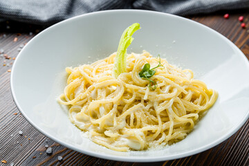 spaghetti Oli Olio on white plate on wooden table