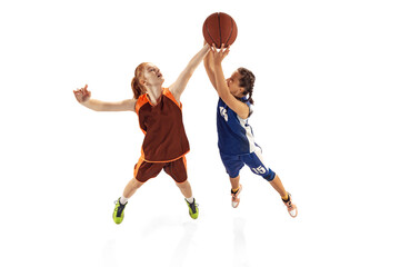 Play defense. Two basketball players, young girls, teen training with basketball ball isolated on...
