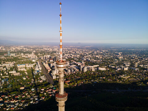 The symbol of the city of Almaty, the kok-tobe television tower. TV tower against the backdrop of the city from a height