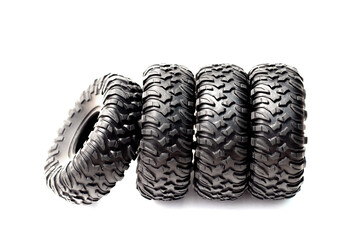 4 rubber toy tires in a row isolated on white background.car repair and maintenance,tires...