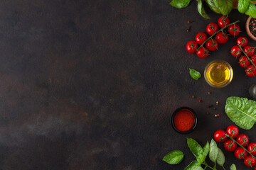 Dark background with tomatoes and basil