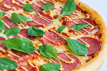 Pizza with spinach close-up
