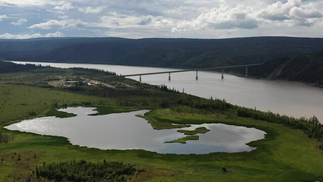 Drone flying over the Yukon river bridge known as the E. L. Patton Bridge along the dalton highway in Alaska during summer