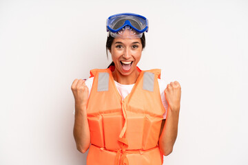 hispanic pretty woman feeling shocked,laughing and celebrating success. life jacket concept