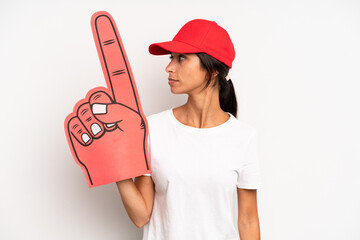 hispanic pretty woman on profile view thinking, imagining or daydreaming. number one hand fan...