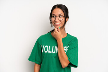 hispanic pretty woman smiling with a happy, confident expression with hand on chin. volunteer...