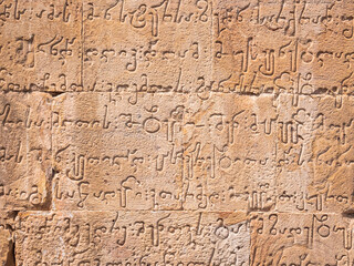 Fototapeta na wymiar ancient Georgian writing at temple stone wall
