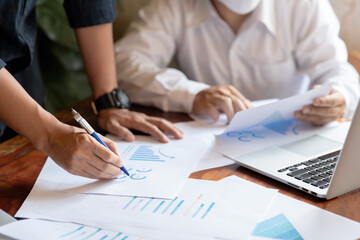 Close-up of two business people meeting to analyze and plan investment marketing financial report data on the table in office.