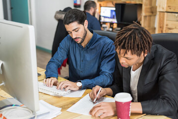 Focused multiethnic colleagues working in office