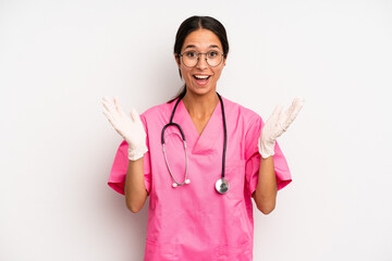 hispanic pretty woman feeling happy and astonished at something unbelievable. veterinarian student...