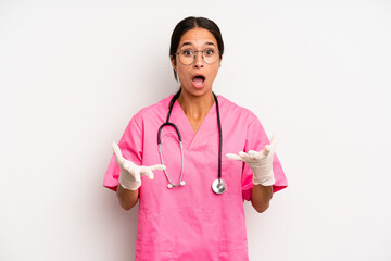 hispanic pretty woman feeling extremely shocked and surprised. veterinarian student concept