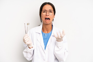 hispanic pretty woman looking desperate, frustrated and stressed. dentist student concept