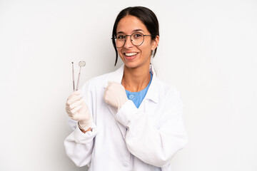 hispanic pretty woman feeling happy and facing a challenge or celebrating. dentist student concept