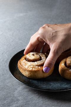 Anonymous Person Eating Cinnamon Roll Bun