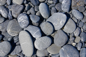 smooth black and gray pebbles on the beach