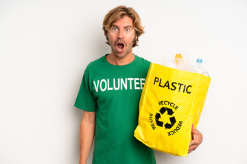 blond adult man looking very shocked or surprised. ecology concept